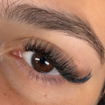Client wearing YY eyelash extensions showing natural full volume and soft curl