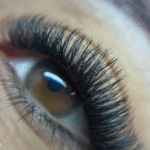 Close up of YY eyelash extensions on client for long lasting lift and defined look