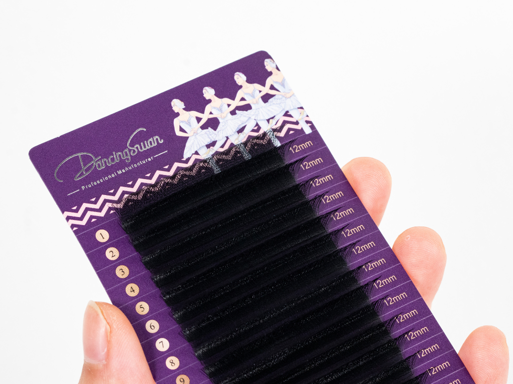 Hand holding W 3D lash extensions showing lightweight soft fibers