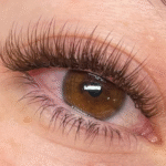 Full brown eyelash extensions enhancing eye definition